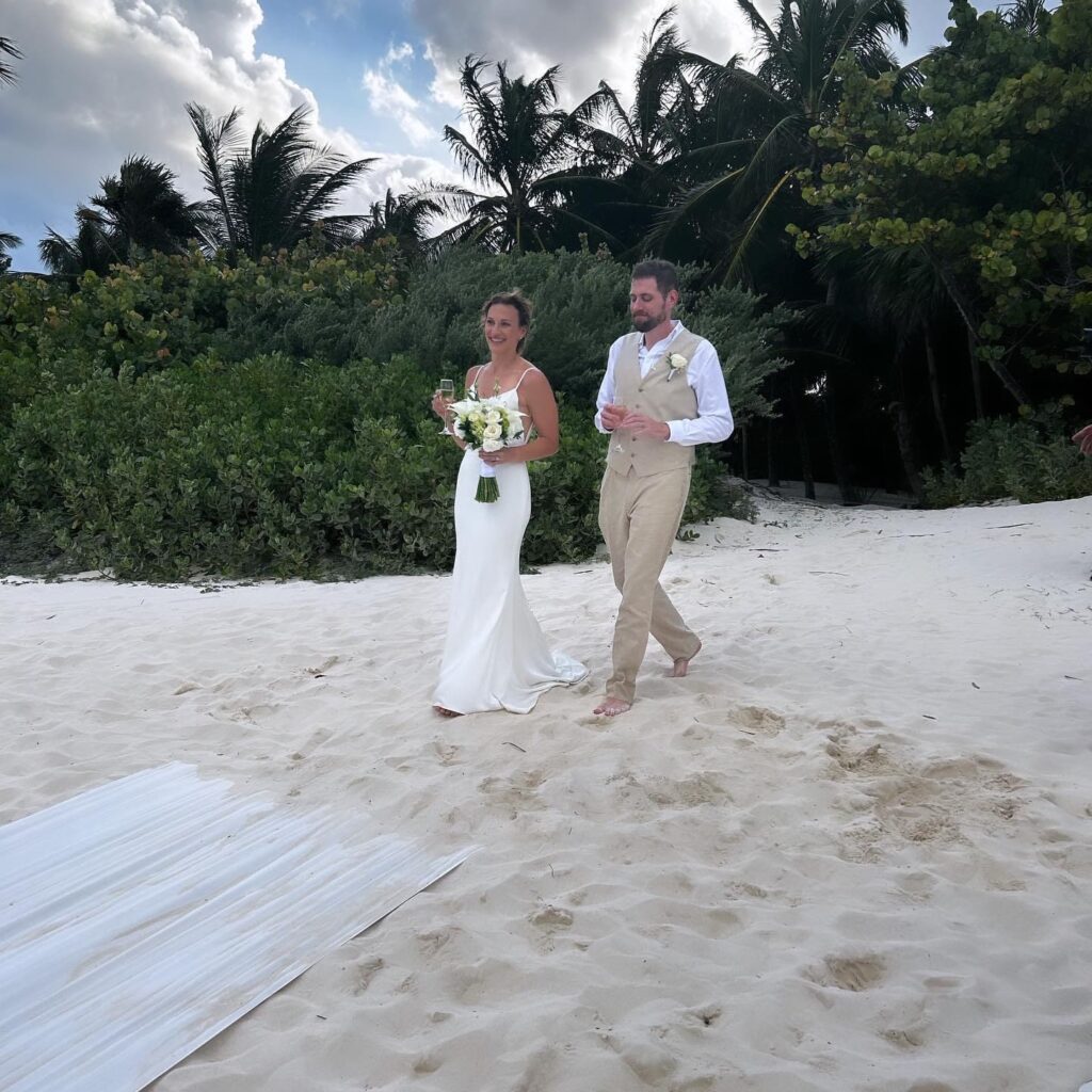 Bride and groom walking on the beach