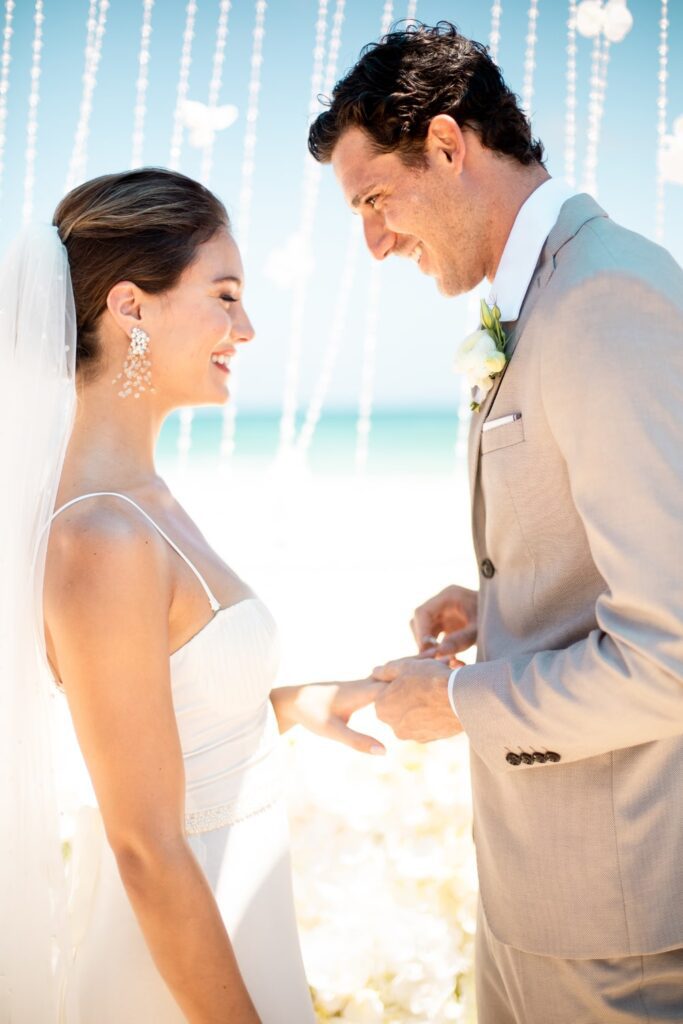 Bride and groom exchanging rings while getting married in Mexico