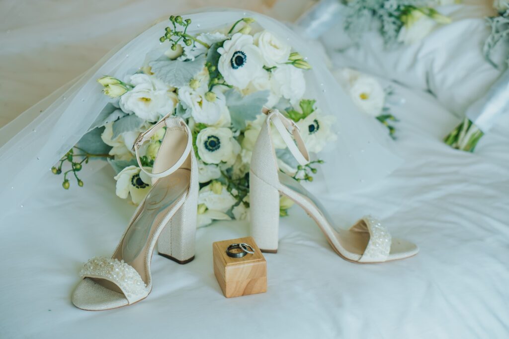 Bridal bouquet with white flowers and white pearl wedding heels