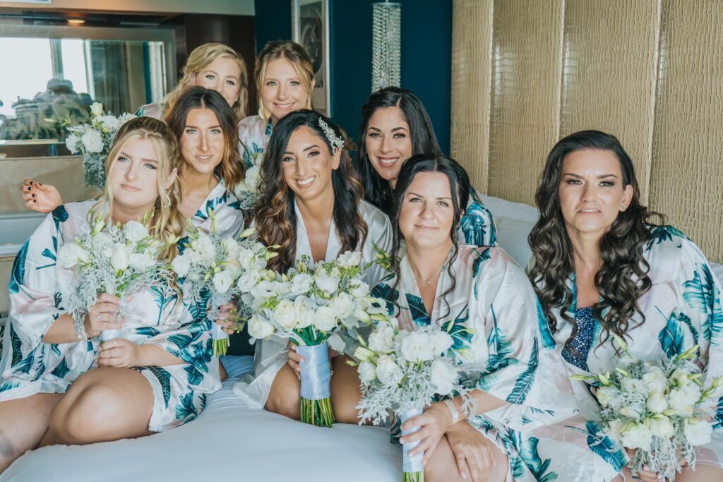 Bridesmaids in satin bridesmaid robes with tropical print