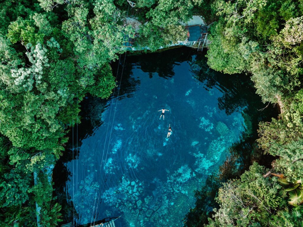 People Swimming in Cenote in Riviera Maya