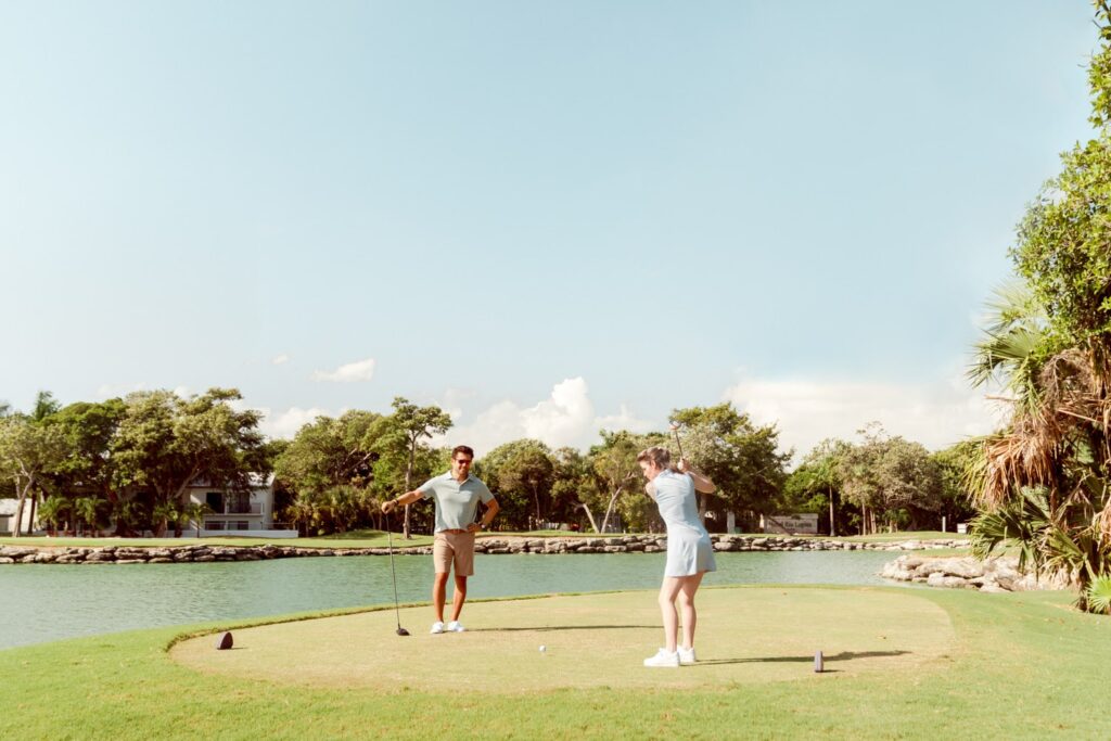 Man & women golfing at Riviera Maya resort