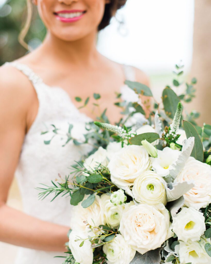 Bride holding a white bridal bouquet at her all-inclusive resort wedding