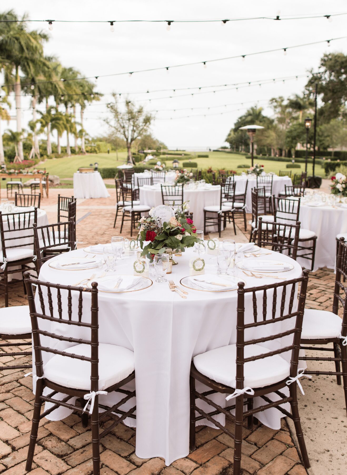 Destination wedding in Mexico wedding reception with white linens and brown chairs at all inclusive resort