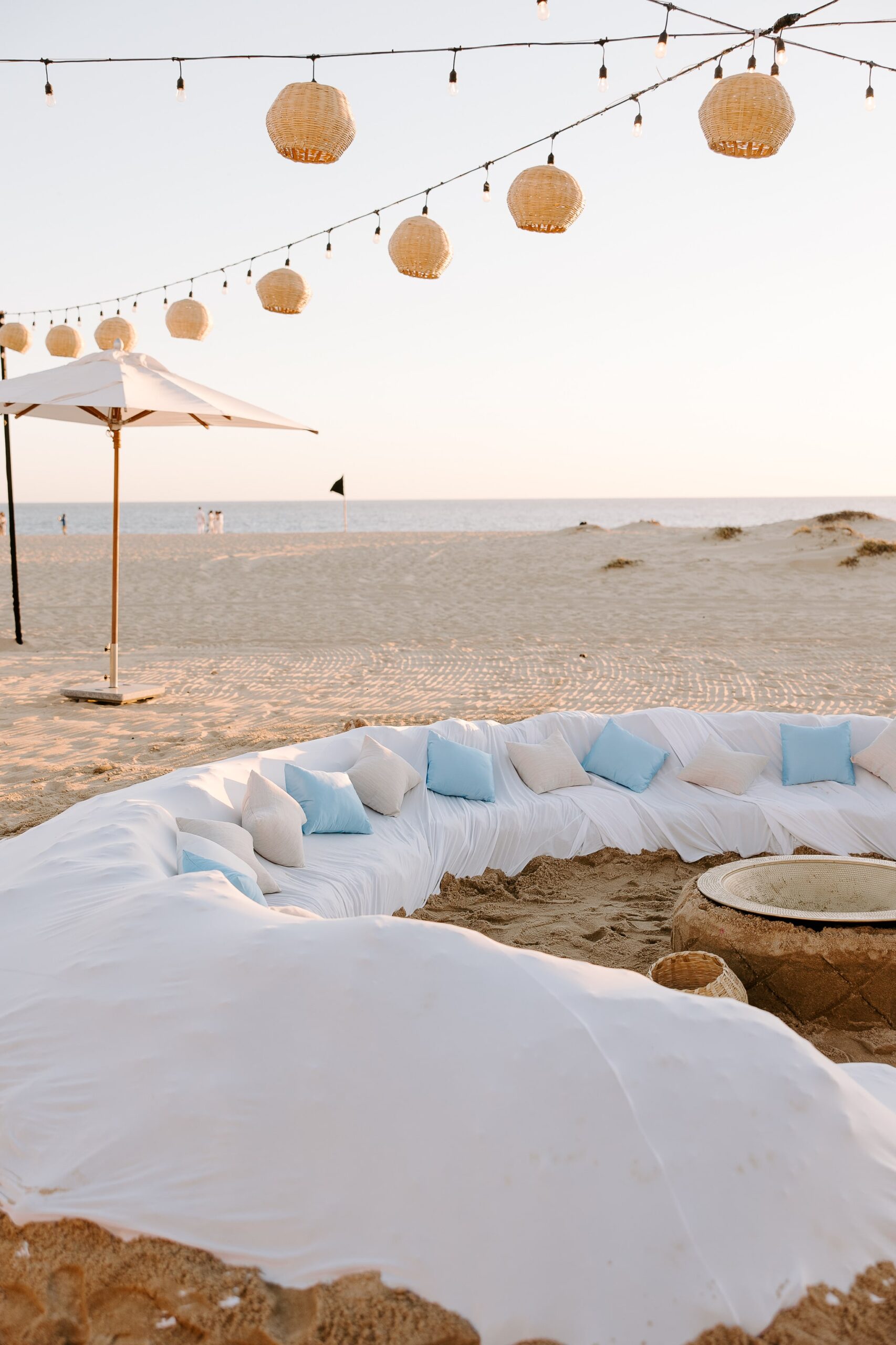 A fire pit lounge on the beach at a wedding weekend welcome party at Hard Rock Cabo