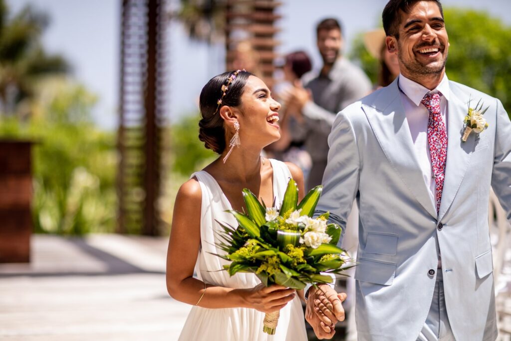 Bride smiling at groom holding wedding bouquet