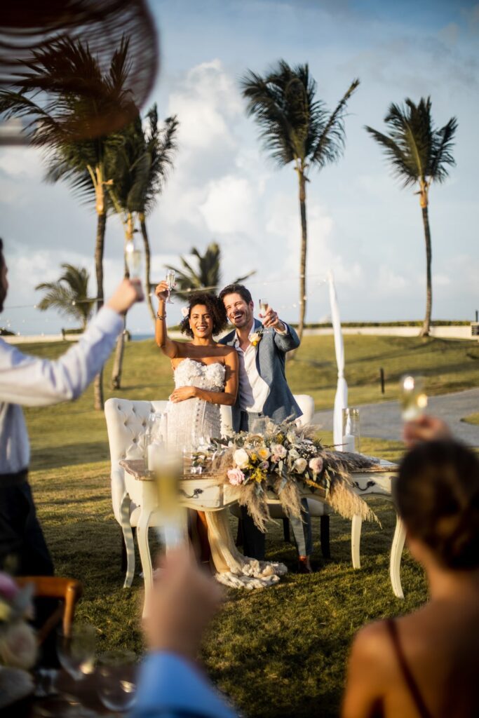 Bride and groom toasting guests at outdoor wedding reception