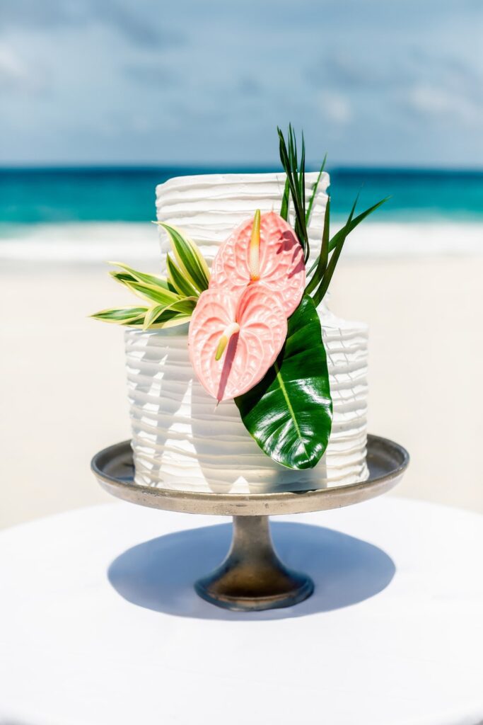 Two tiered wedding cake with tropical wedding flowers