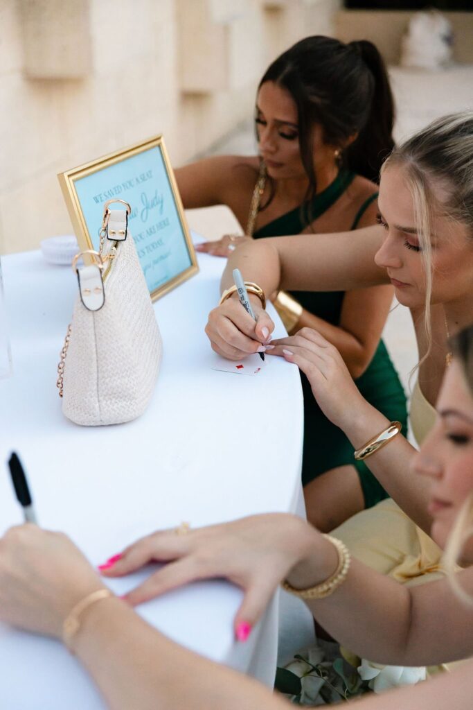 guests signing a playing card guest book