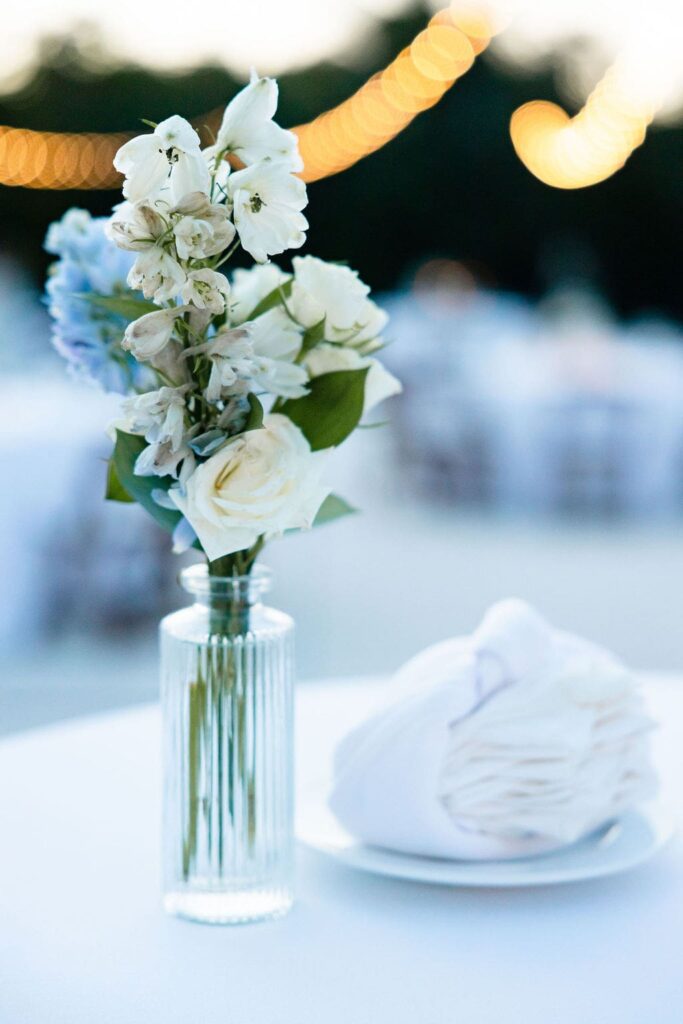 blue and white flowers in a bud vase