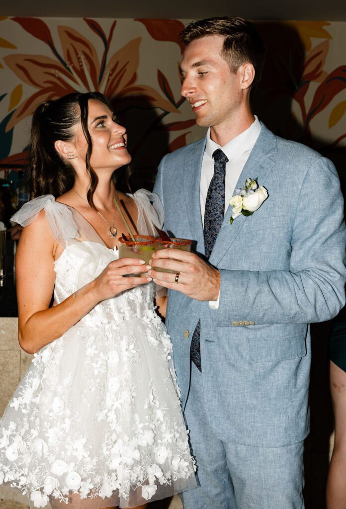bride and groom cheersing margaritas
