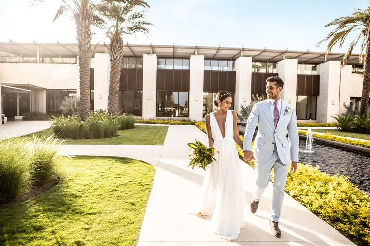 Bride and groom holding hands during wedding portraits at UNICO 20°87° Hotel Riviera Maya wedding