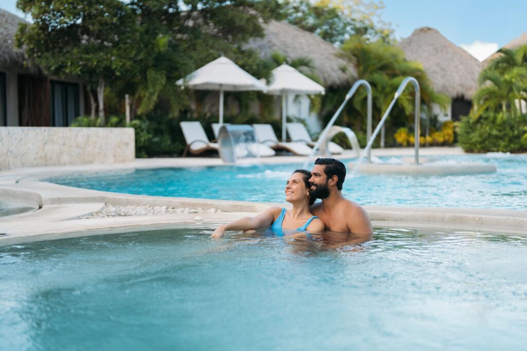 Adults sitting in the pool at a All-Inclusive resort