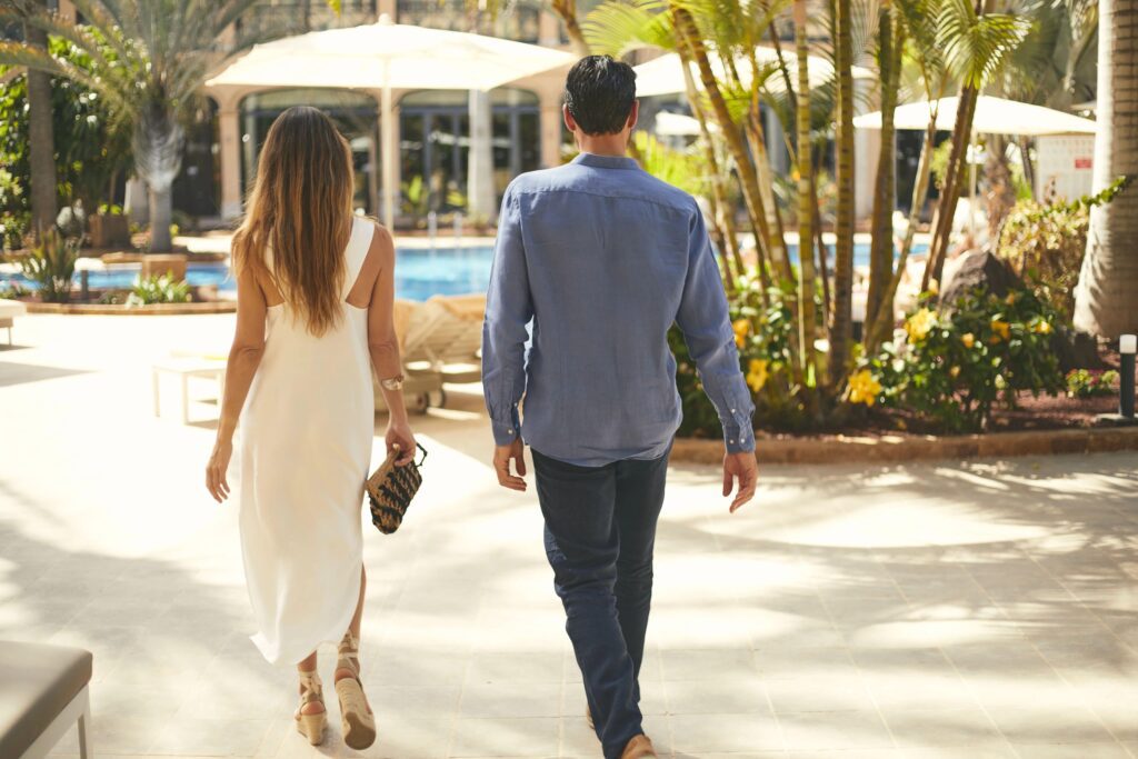 Engaged couple walking a Mexico wedding venue during a destination wedding site visit