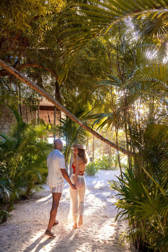 Engaged couple walking a Mexico wedding venue during a destination wedding site visit
