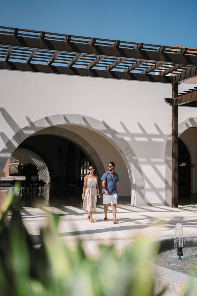 Engaged couple walking a Mexico wedding venue during a destination wedding site visit