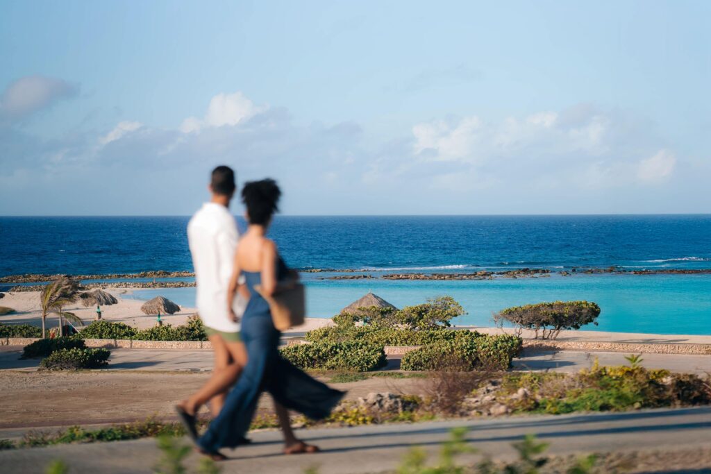 Couple holding hands waling near the beach