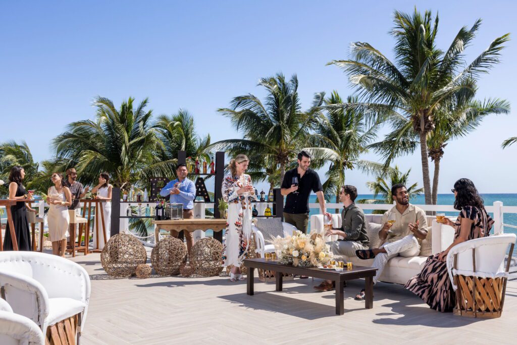 Wedding guests sitting on sofas drinking drinks