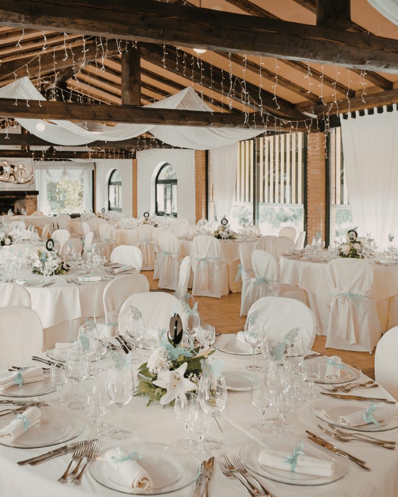 Wedding reception decor with white tables and white chair covers