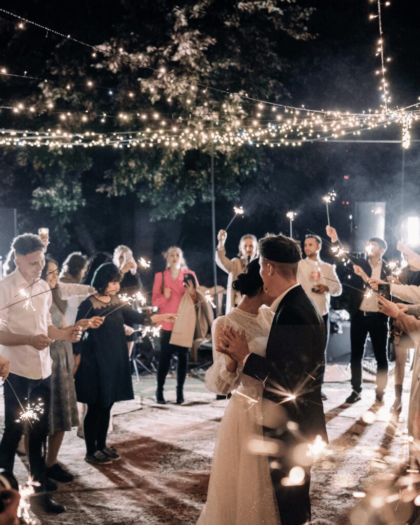 Bride and groom dancing to a sparkler first dance at their large destination wedding