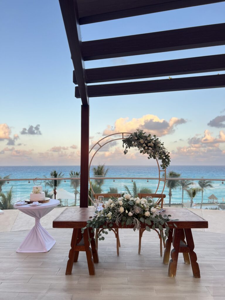Sweetheart table with circle arch backdrop at a Cancun wedding