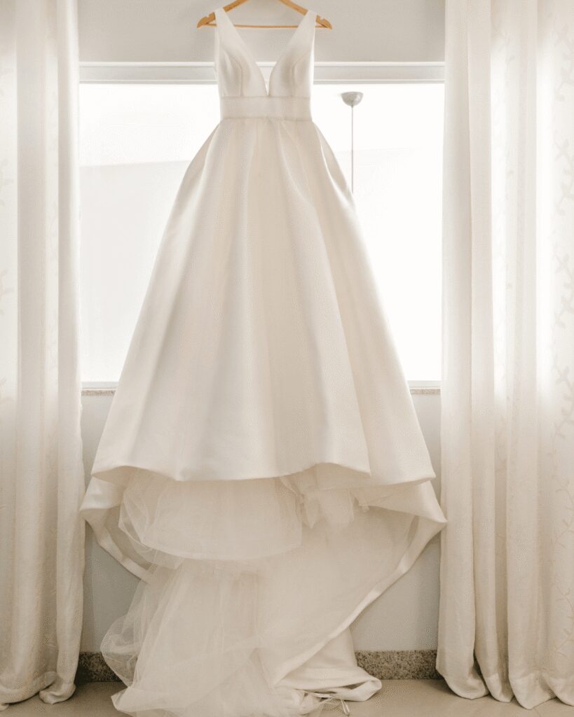 Wedding gown hanging by window