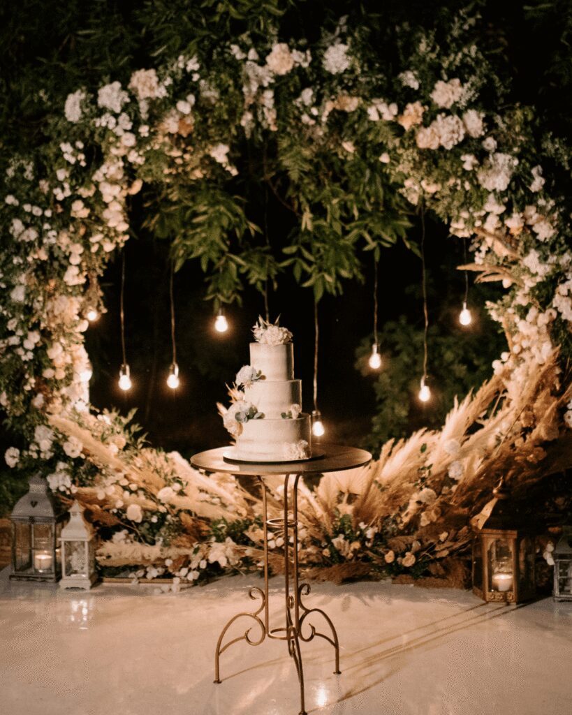 Wedding cake with circle wedding ceremony arch as back drop