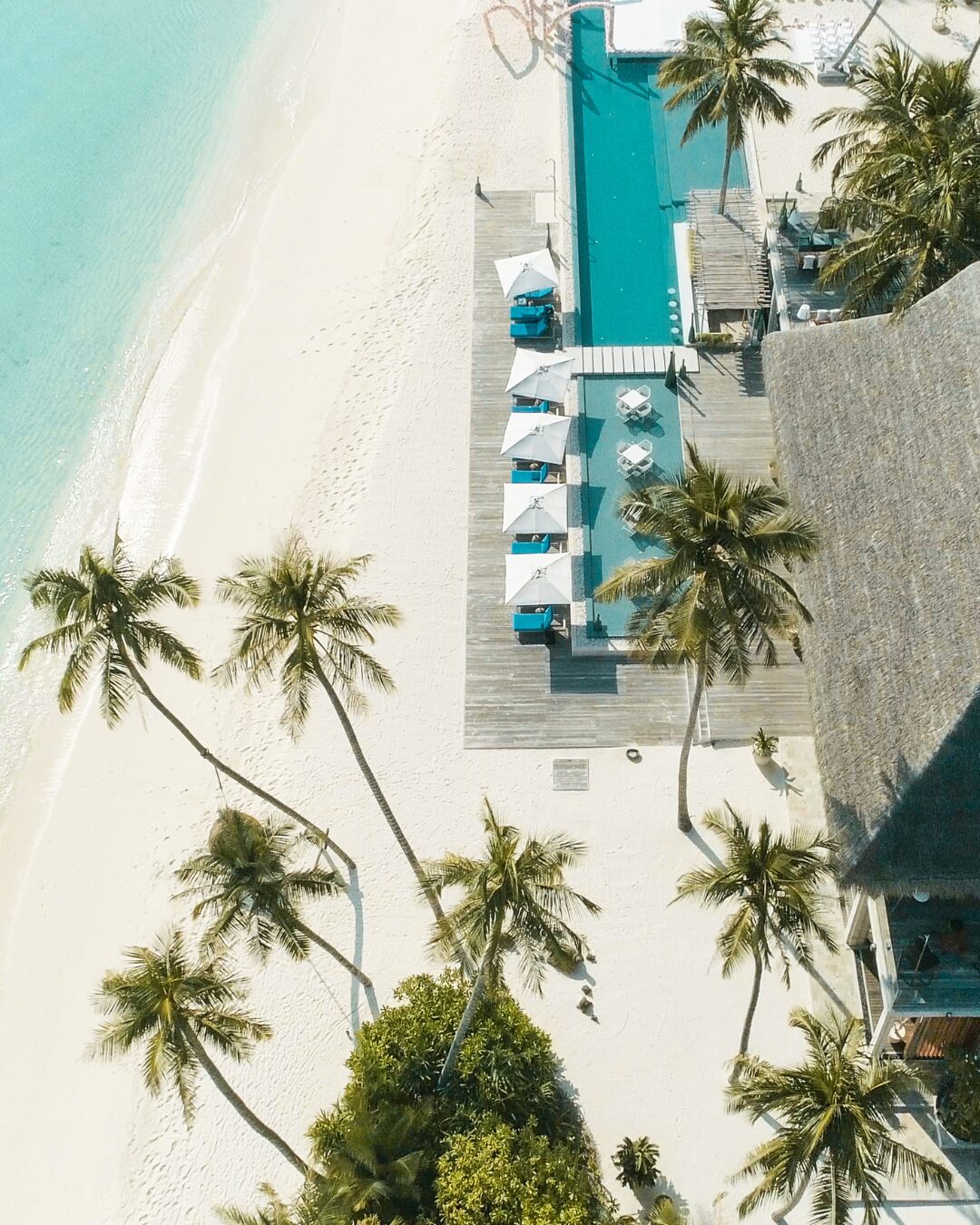 Aerial view of a pool and beach at an all inclusive resort